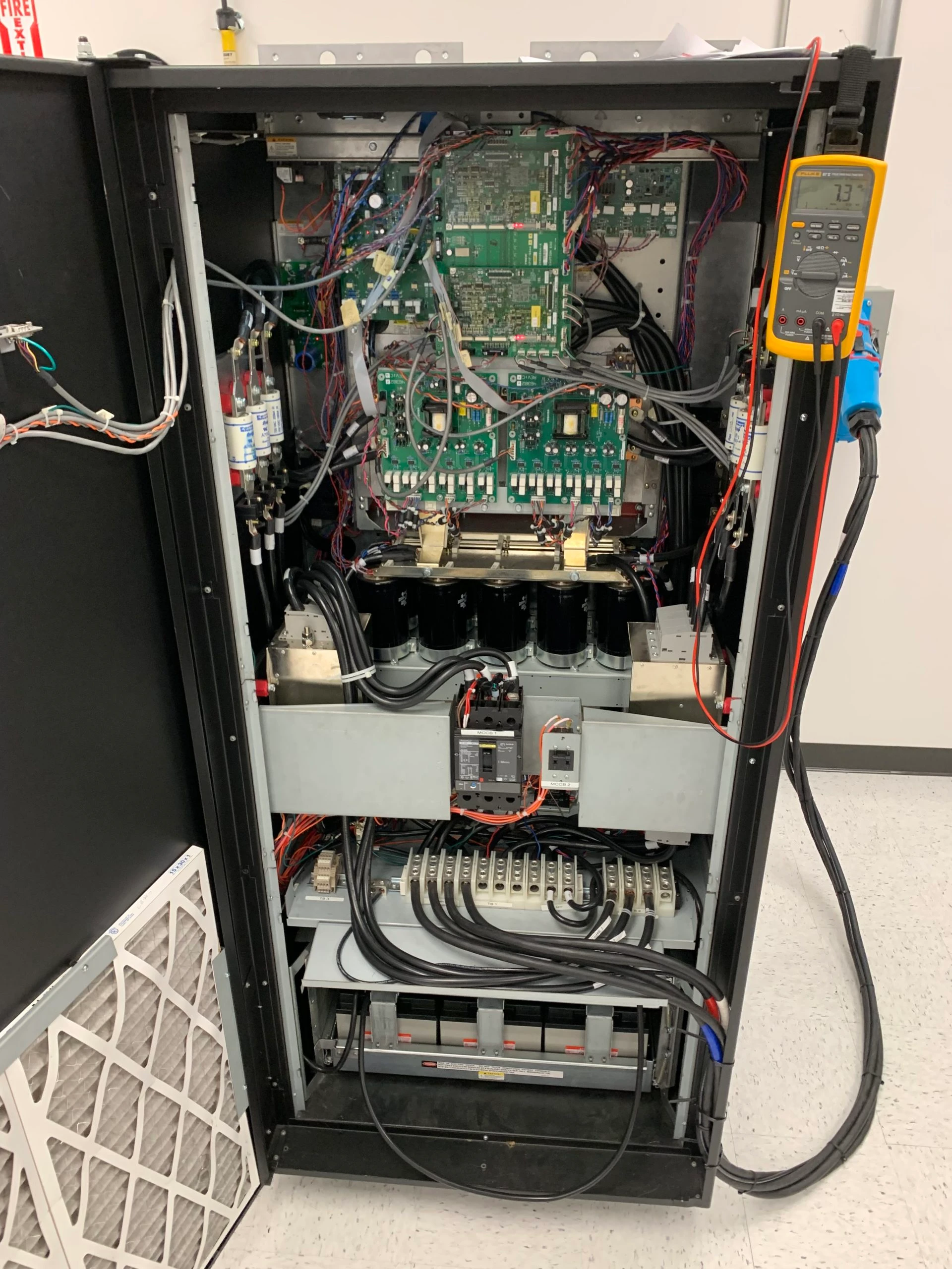 Uninterrupted Power Supply (UPS) system interior showcasing circuit boards, wiring, and components, relevant to Kazar's Electric's Toshiba-certified services for UPS solutions.