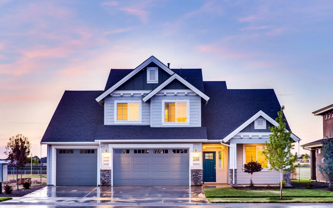 Modern residential home with a well-maintained exterior, featuring a blue front door, multiple windows, and a landscaped yard, symbolizing safety and comfort during hurricane preparations.
