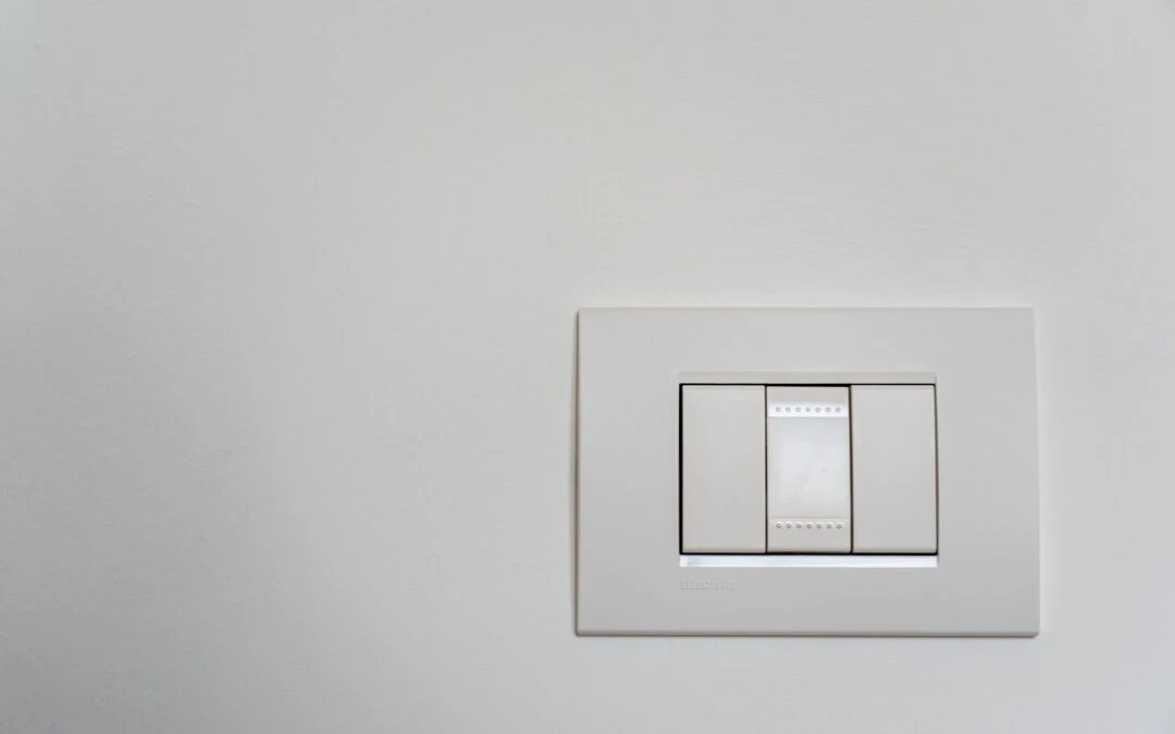 Dimmer switch installed on a light-colored wall, illustrating modern lighting control for improved ambiance and energy efficiency in homes.